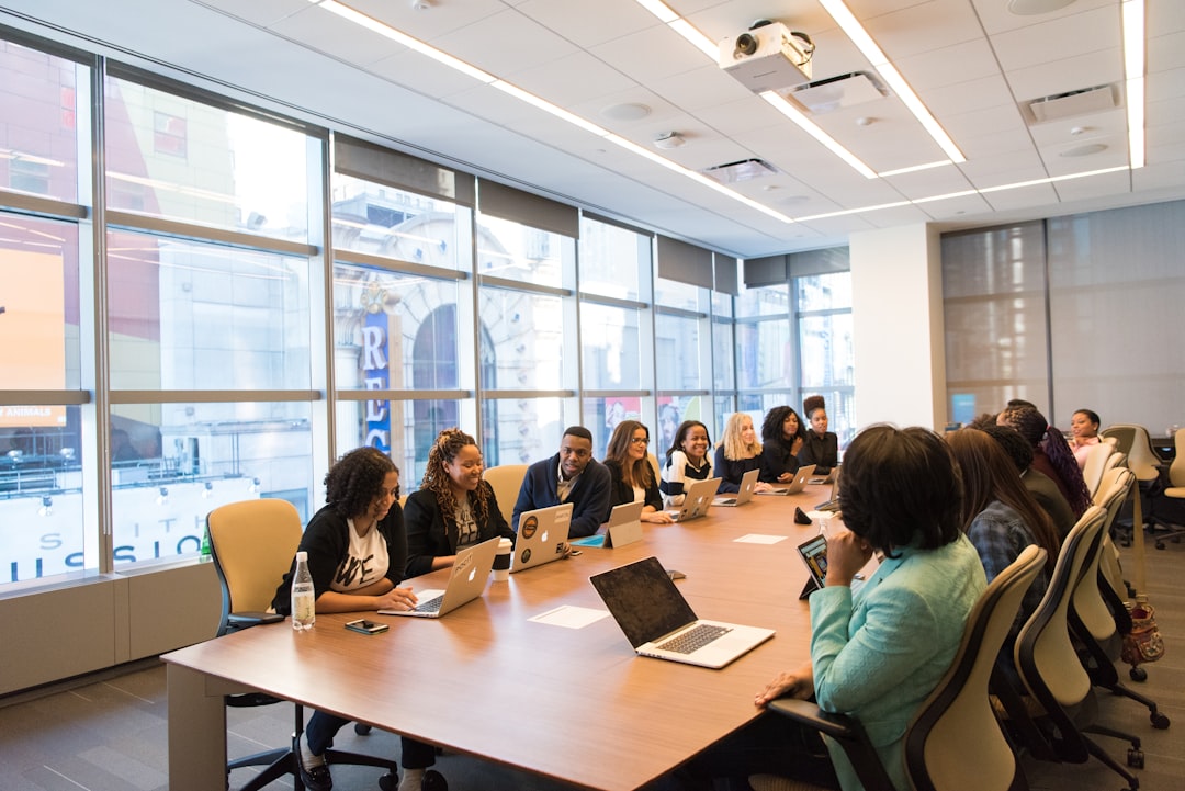 about-img-01 group-of-people-sitting-beside-rectangular-wooden-table-with-laptops-faefwcdokig