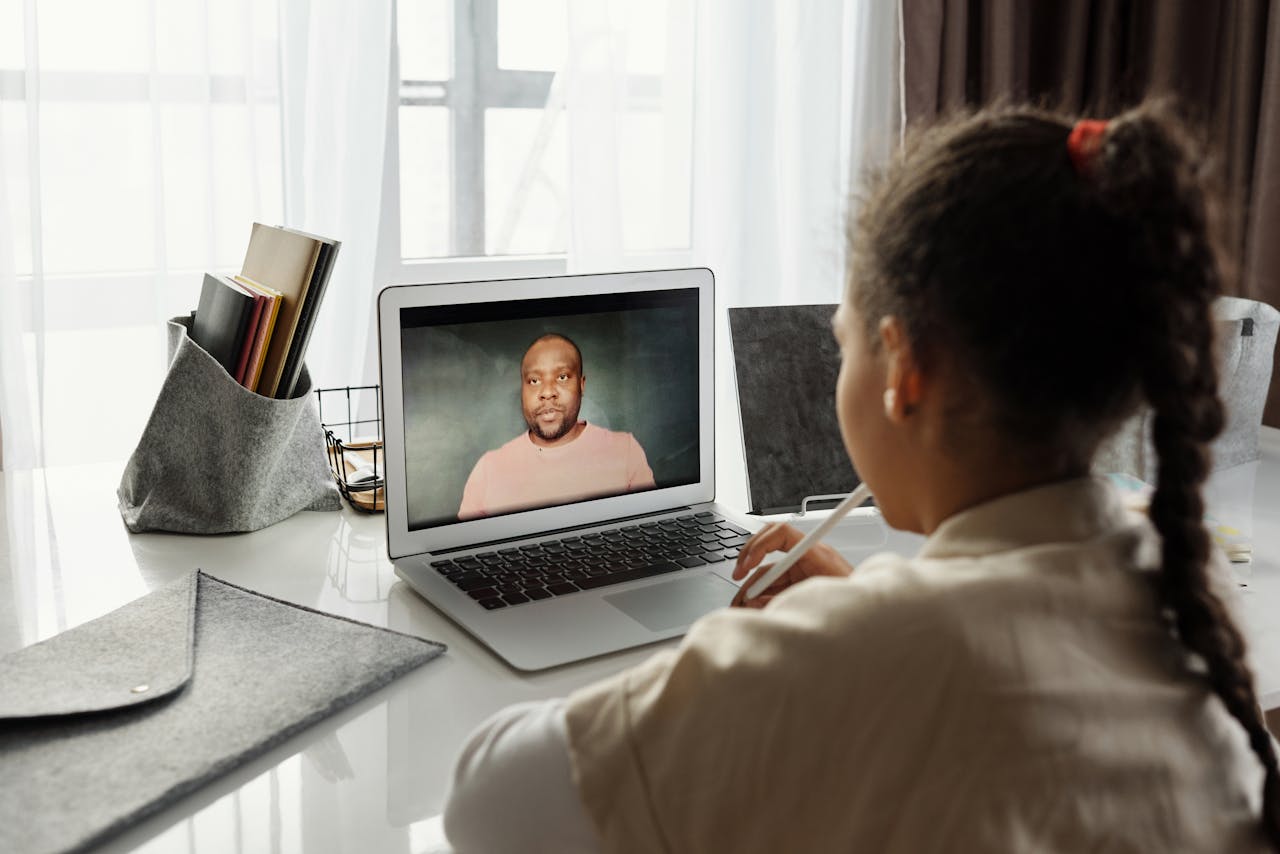 about-img-02 Child attending an online lesson at home via laptop. Remote education.